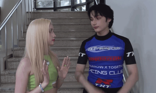 A Man And A Woman Are Standing Next To Each Other Wearing Shirts That Say Racing Club GIF