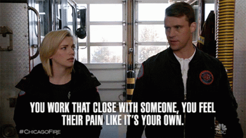 A Man And A Woman Are Standing Next To Each Other With A Caption That Says " You Work That Close With Someone " GIF