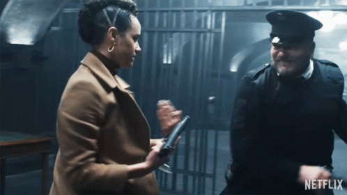 A Man And A Woman Are Standing Next To Each Other With A Netflix Logo On The Bottom GIF