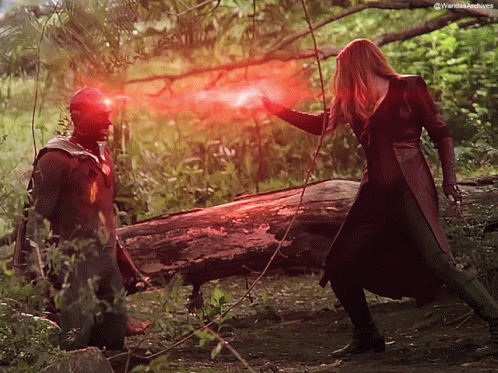 A Man And A Woman Are Standing Next To Each Other With A Red Light Coming Out Of Their Eyes . GIF