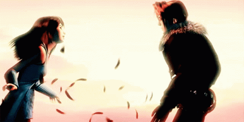 A Man And A Woman Are Standing Next To Each Other With Feathers Flying Around Them GIF