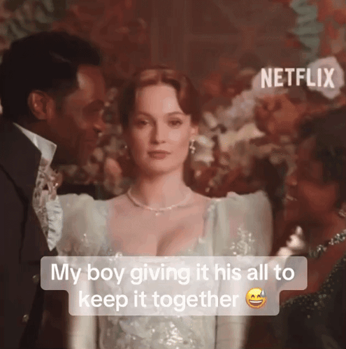 A Man And A Woman Are Standing Next To Each Other With The Caption " My Boy Giving It His All To Keep It Together GIF