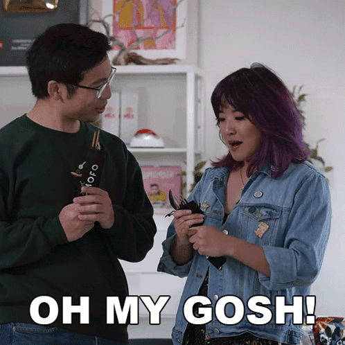 A Man And A Woman Are Standing Next To Each Other With The Woman Saying Oh My Gosh GIF