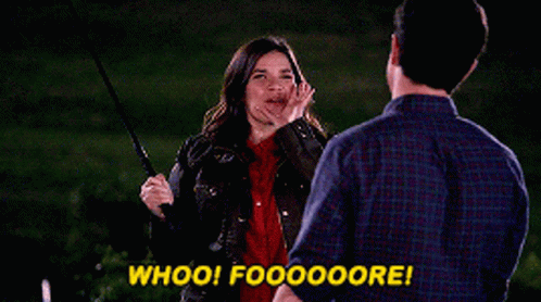 A Man And A Woman Are Standing Next To Each Other With The Woman Saying Whoo ! GIF
