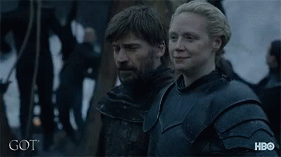 A Man And A Woman Are Standing Next To Each Other With The Word Got On The Bottom Right GIF