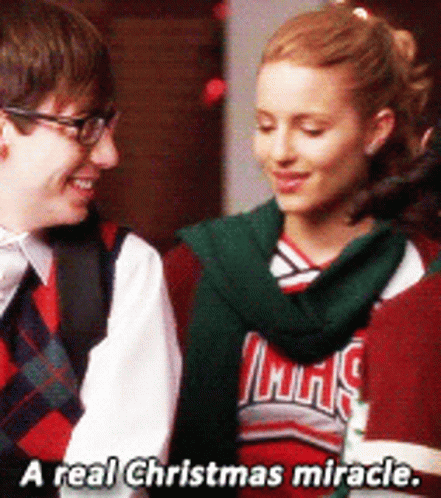 A Man And A Woman Are Standing Next To Each Other With The Words " A Real Christmas Miracle " On The Bottom GIF