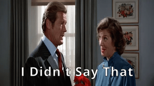 A Man And A Woman Are Standing Next To Each Other With The Words I Did N't Say That Written Above Them GIF