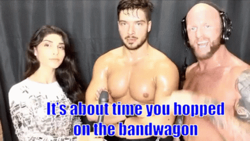 A Man And A Woman Are Standing Next To Each Other With The Words It 'S About Time You Hopped On The Bandwagon GIF