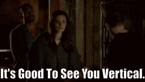 A Man And A Woman Are Standing Next To Each Other With The Words It 'S Good To See You Vertical GIF