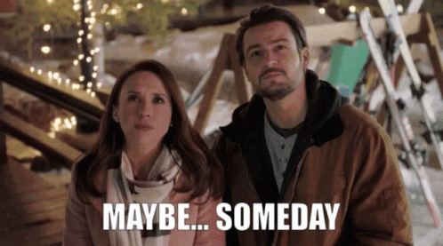 A Man And A Woman Are Standing Next To Each Other With The Words Maybe Someday Written Below Them GIF