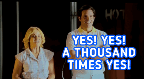 A Man And A Woman Are Standing Next To Each Other With The Words Yes Yes A Thousand Times Yes Behind Them GIF