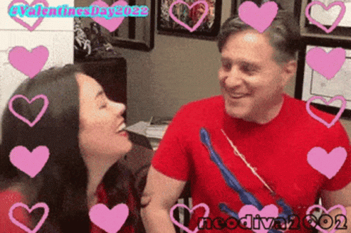 A Man And A Woman Are Surrounded By Pink Hearts With Valentines Day 2022 Written On The Bottom GIF