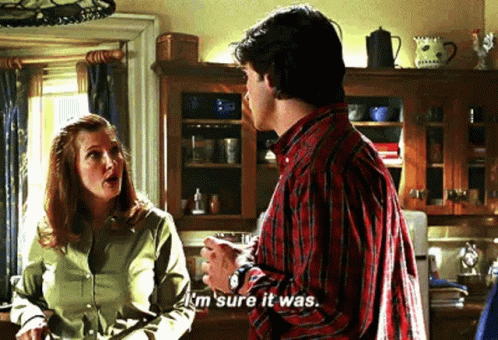 A Man And A Woman Are Talking In A Kitchen And The Man Is Saying `` I 'M Sure It Was . '' GIF