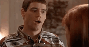 A Man And A Woman Are Talking To Each Other And The Man Is Making A Surprised Face . GIF