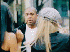 A Man And A Woman Are Talking To Each Other In A Blurry Photo GIF