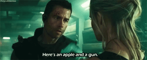 A Man And A Woman Are Talking To Each Other In A Dark Room . GIF