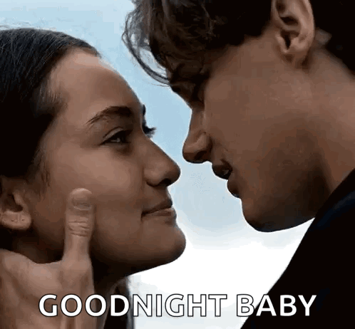 A Man And A Woman Are Touching Each Other 'S Faces . GIF