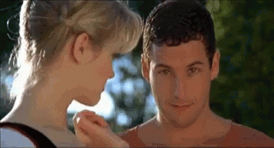 A Man And A Woman Are Touching Each Other 'S Faces In A Movie . GIF