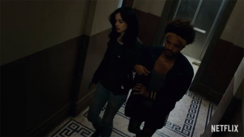 A Man And A Woman Are Walking Down A Hallway And The Word Sobriety Blows Is On The Bottom GIF