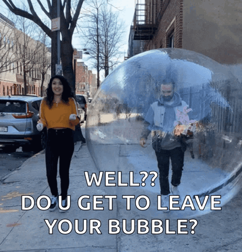A Man And A Woman Are Walking Down A Sidewalk With A Clear Bubble Behind Them That Says Well GIF