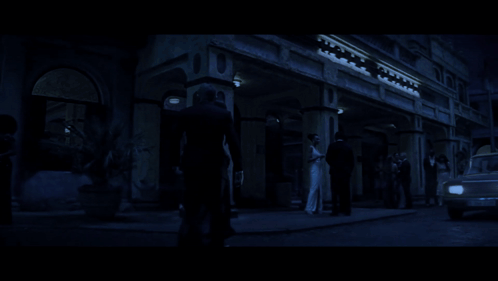 A Man And A Woman Are Walking In The Dark GIF