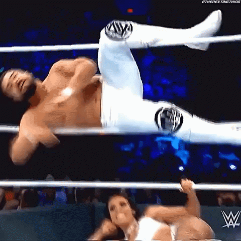 A Man And A Woman Are Wrestling In A Wrestling Ring . The Woman Is Holding The Man 'S Leg . GIF