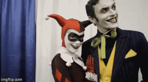 A Man And A Woman Dressed As Harley Quinn And The Joker Pose For A Picture GIF