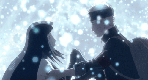 A Man And A Woman Hold Hands In The Snow GIF