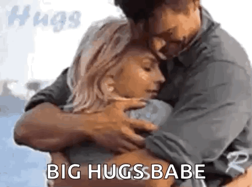 A Man And A Woman Hugging Each Other With The Words `` Big Hugs Babe '' . GIF