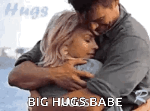 A Man And A Woman Hugging Each Other With The Words `` Big Hugs Babe '' . GIF
