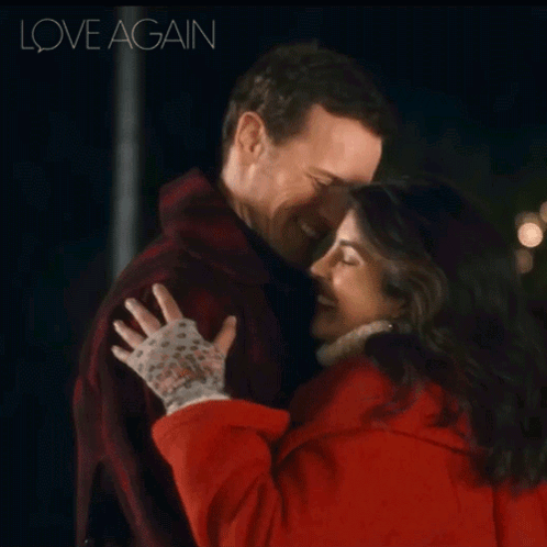 A Man And A Woman Hugging With The Words Love Again Behind Them GIF