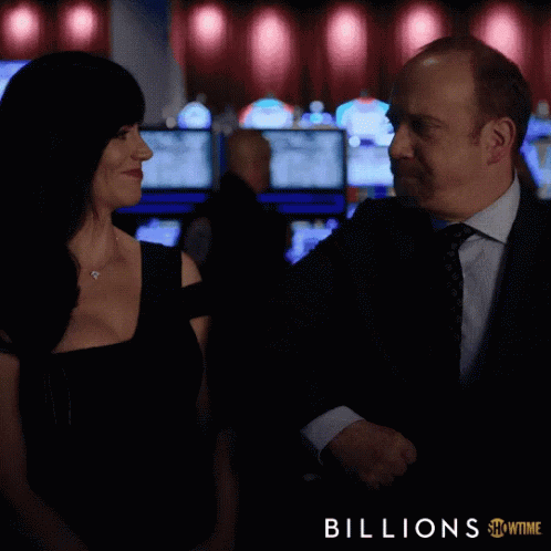 A Man And A Woman In A Casino With The Words Let 'S Go Act Like Winners Below Them GIF