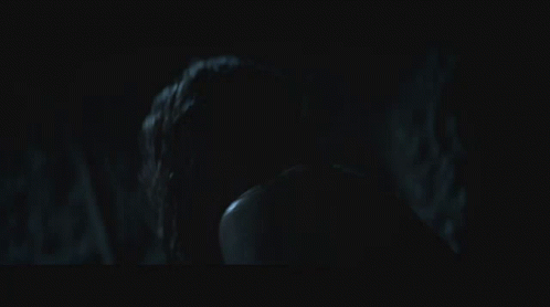 a man and a woman in a dark room