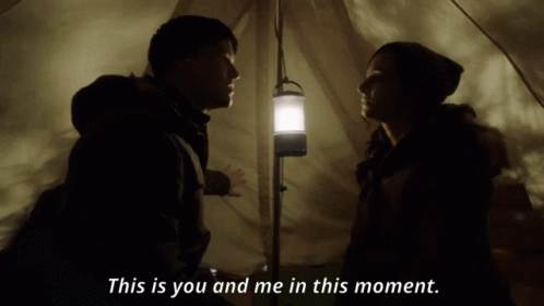 A Man And A Woman In A Tent With The Words This Is You And Me In This Moment Below Them GIF