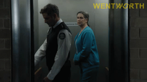 A Man And A Woman In An Elevator With The Word Wentworth On The Top GIF