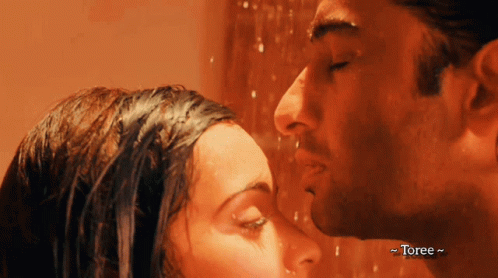 A Man And A Woman Kissing In A Shower With Toree Written On The Bottom Right GIF