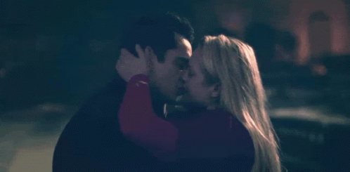 A Man And A Woman Kissing In The Dark GIF