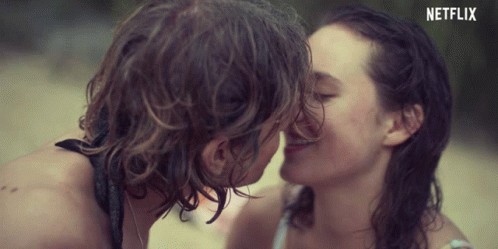 A Man And A Woman Kissing With A Netflix Logo In The Background GIF