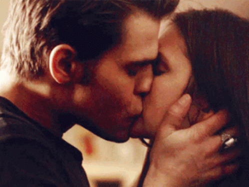 A Man And A Woman Kissing With The Man Wearing A Ring On His Finger GIF