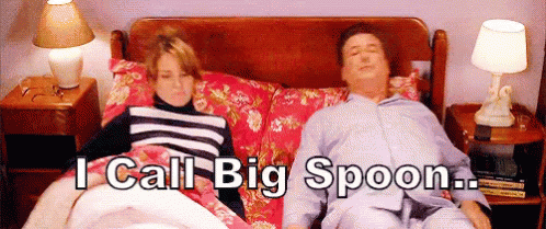 A Man And A Woman Laying In Bed With The Words " I Call Big Spoon " Written Above Them GIF