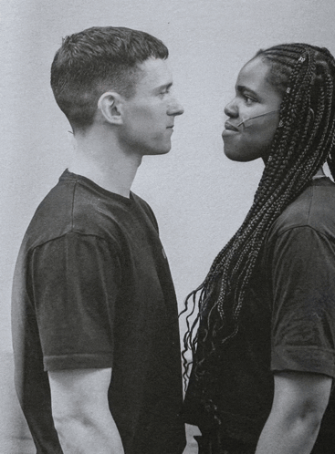 A Man And A Woman Looking At Each Other GIF