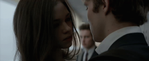 A Man And A Woman Looking Into Each Other 'S Eyes GIF