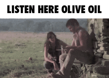 A Man And A Woman Sit In A Field With The Words Listen Here Olive Oil GIF