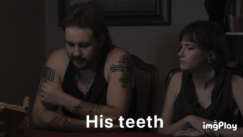 A Man And A Woman Sitting At A Table With The Words His Teeth On The Bottom GIF