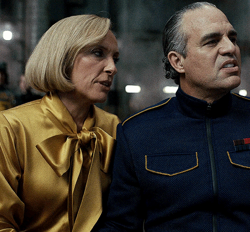 A Man And A Woman Sitting Next To Each Other GIF