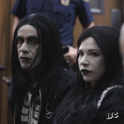 A Man And A Woman Sitting Next To Each Other With The Letters Ifc On The Bottom Right GIF