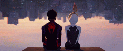 A Man And A Woman Sitting On A Ledge Looking At A City Skyline GIF