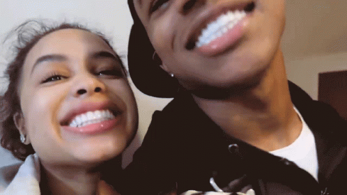 A Man And A Woman Smile For A Picture Together GIF