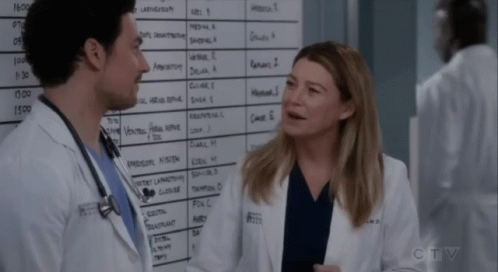 Man And Woman Standing In Front Of CTV Whiteboard GIF