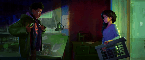 A Man And A Woman Standing Next To Each Other In A Room GIF